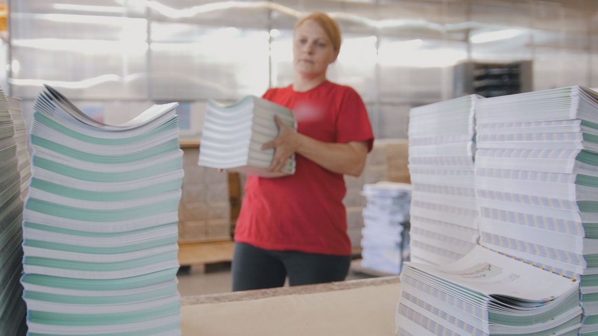 Female Worker Stacking Paper